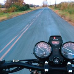 First person view riding a motorcycle. Description follows.